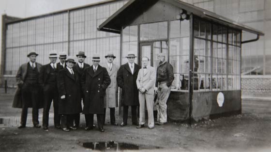 Ten Men In Front of Hangar, Date & Location Unknown (Source: Howard)