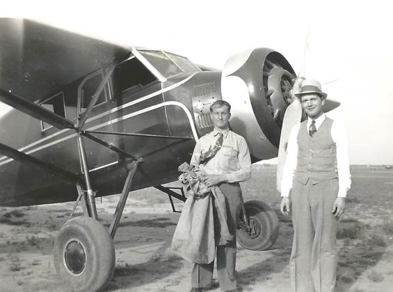 Charlie Angell With Airmail Sacks And Unidentified Man. Stinson SM8A NC247W In Background; Ca.1938 (Source: Angell Family)