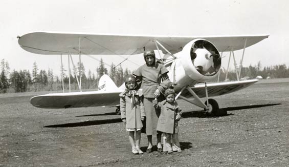 While the Waco’s Propeller Turns in the Background, Mrs. Myra Collier Holds onto her Children Prior to Boarding the Airplane for an Unforgettable Air Journey From Tacoma, WA to Blanket, TX, June 1935 (Source: Ringhoffer via Woodling)